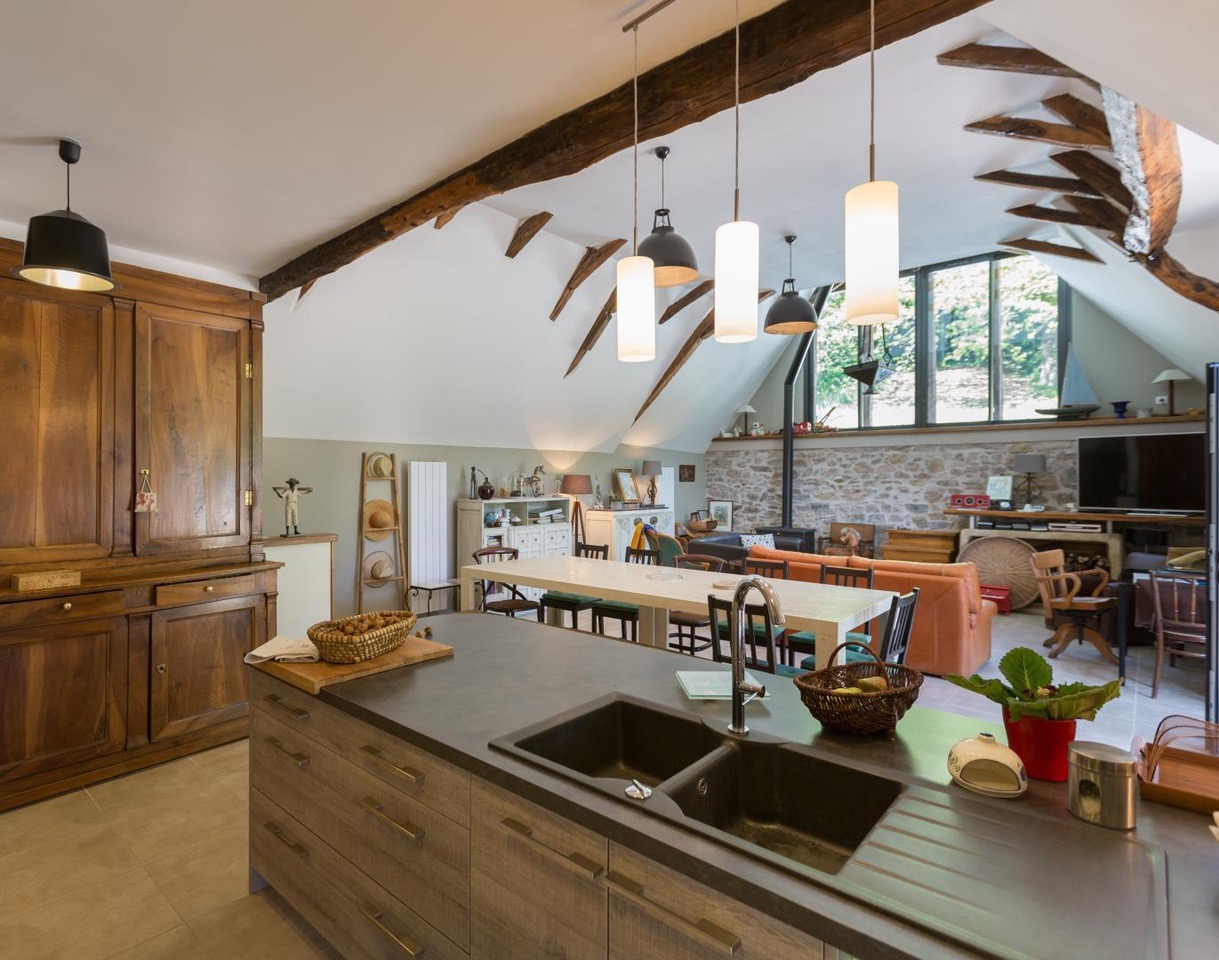 Open-plan living and dining area with exposed beams