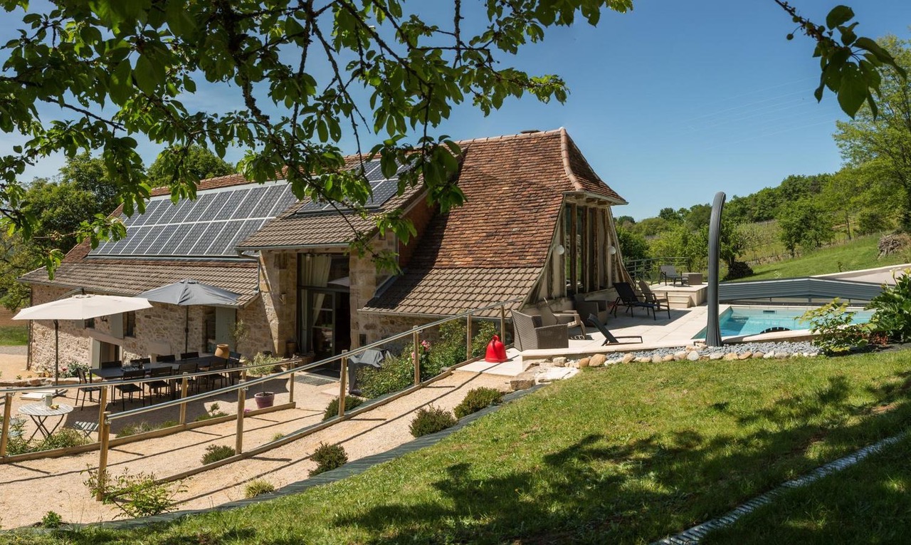 The restored stone grange with solar roof and terrace